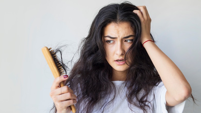 woman losing hair from stress