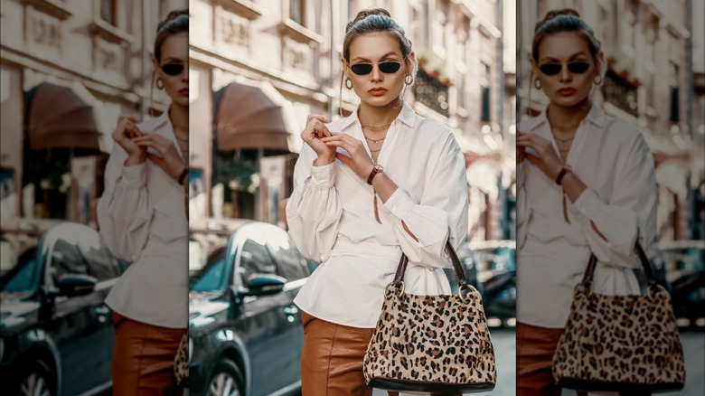Woman holding an animal-print handbag 