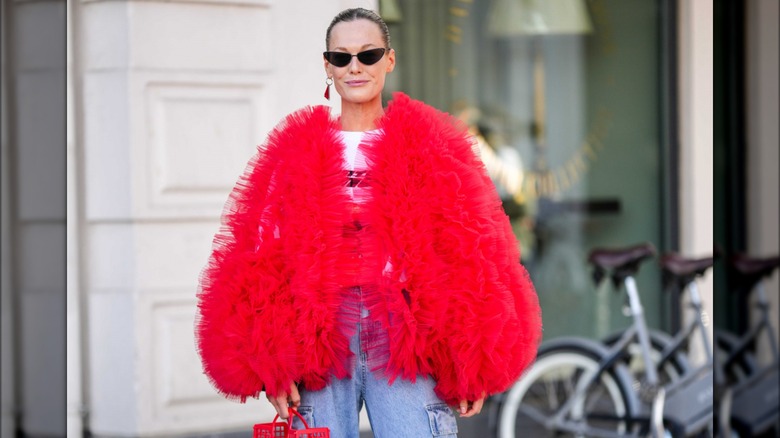 Woman wearing red ruffled jacket