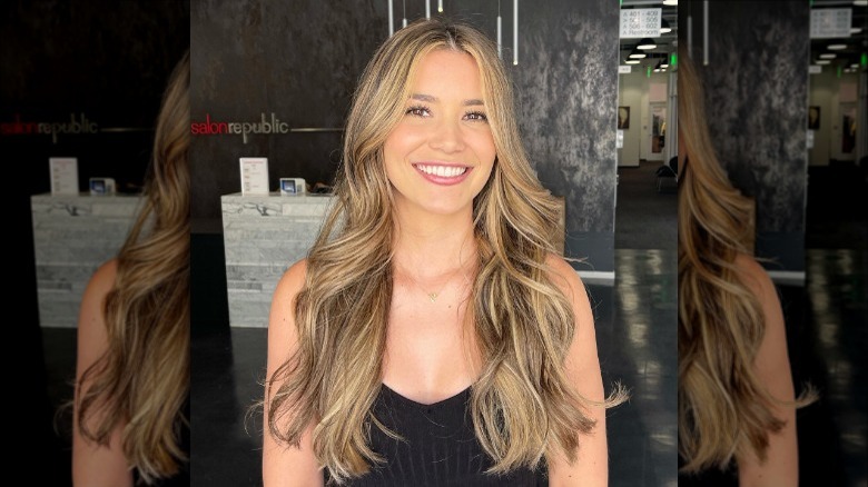 woman showing new hair at salon