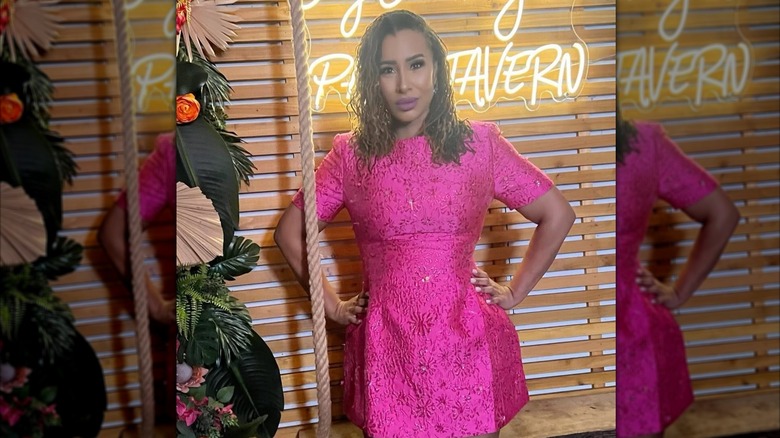 Mikki Bey wearing a pink minidress