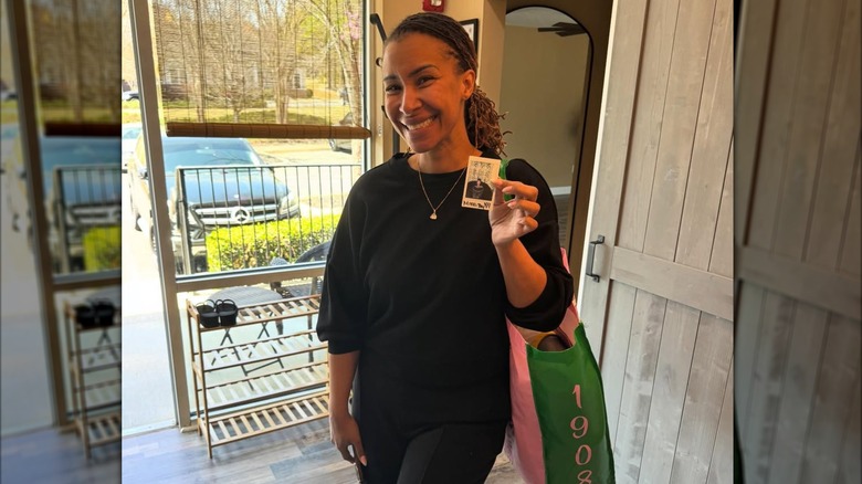 Mikki Bey posing in a black sweater with her hair up