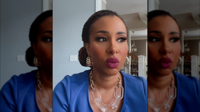 Mikki Bey speaking, dressed in a blue outfit