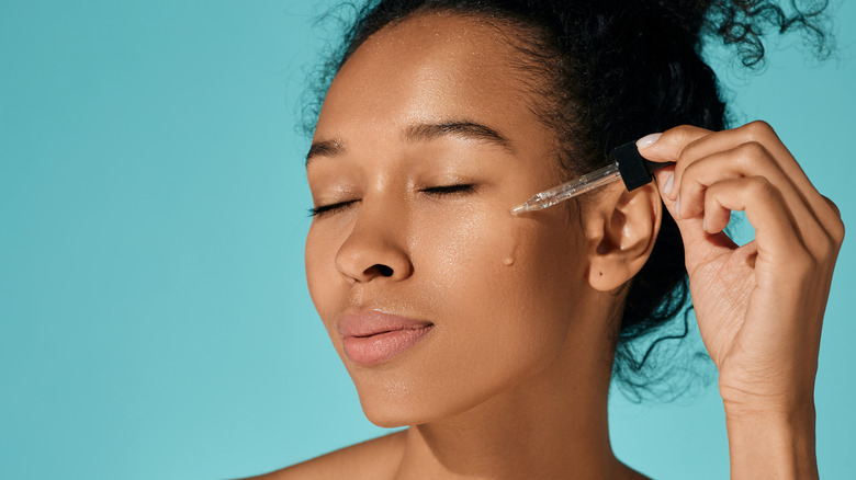 woman applying serum