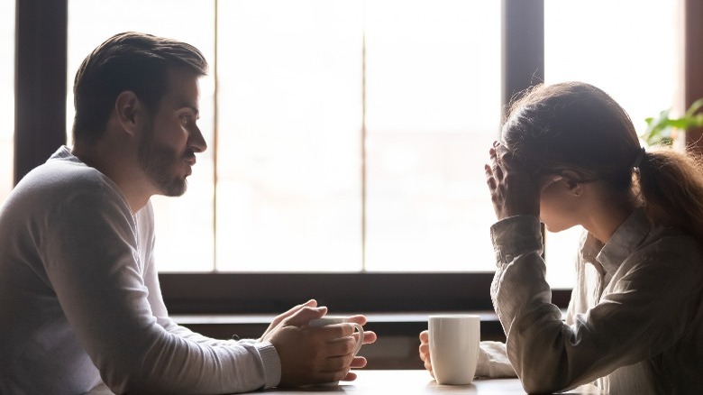 Woman looking away from man