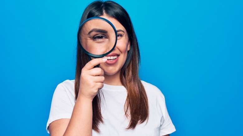 Woman using magnifying glass