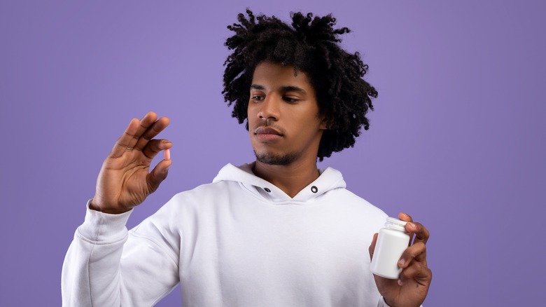 Man taking a prescription pill