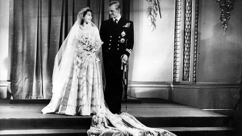 Queen Elizabeth and Prince Phillip standing together after their wedding at Westminster Abbey.