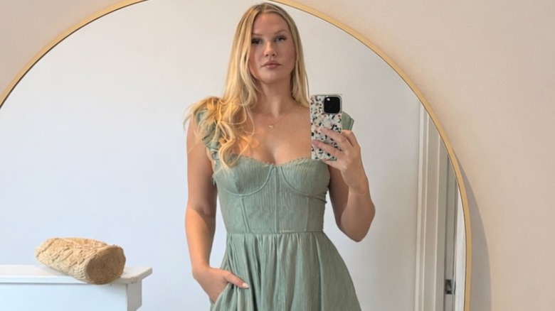 Molly O'Connell posing in a green dress
