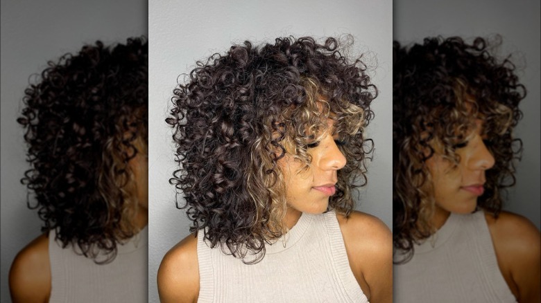 Blond money piece curly brown hair