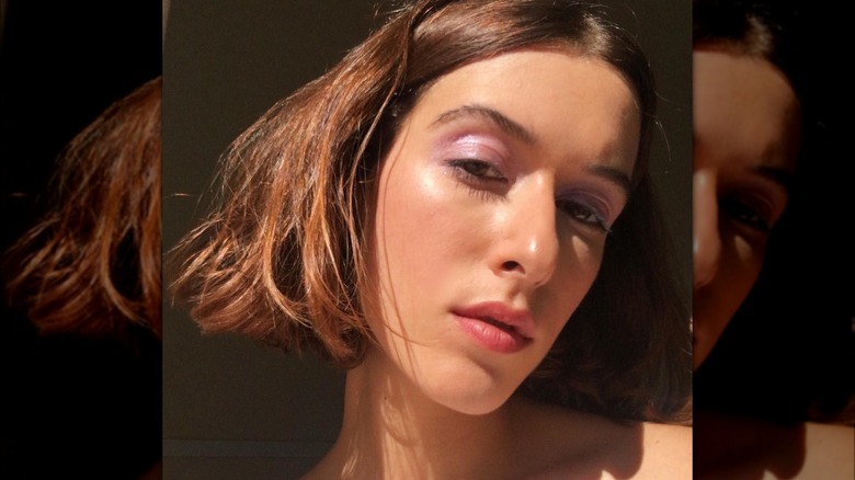 Girl wearing eye gloss.