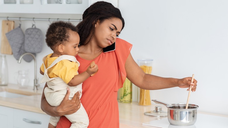 multitasking woman with baby