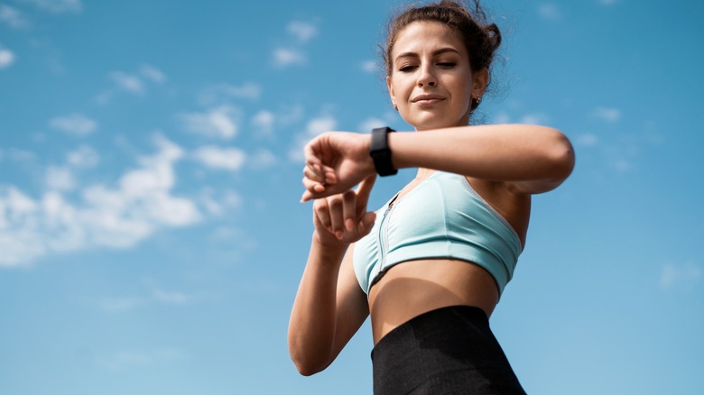 woman checking fitness band