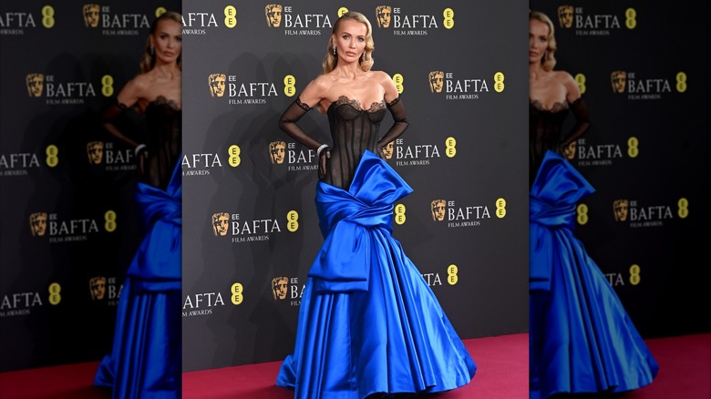 Tatiana Korsakova poses with her hands on her hip on the 2025 BAFTAs red carpet