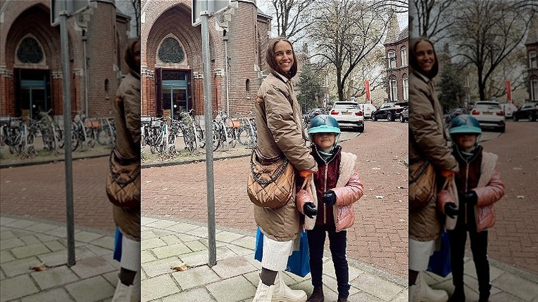 Woman carrying an MZ Wallace purse.