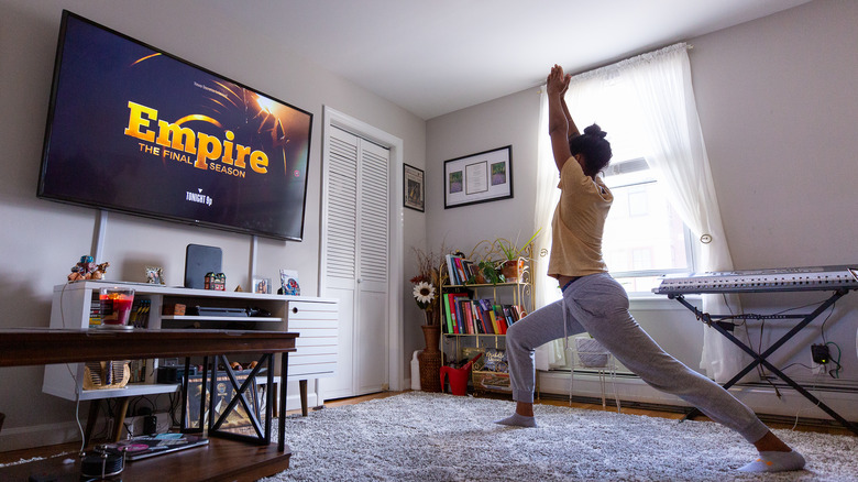Woman exercising while watching tv