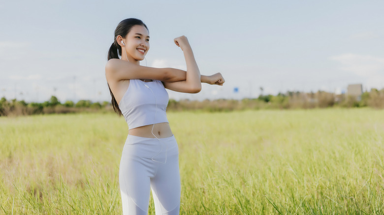 Woman in a field stretching
