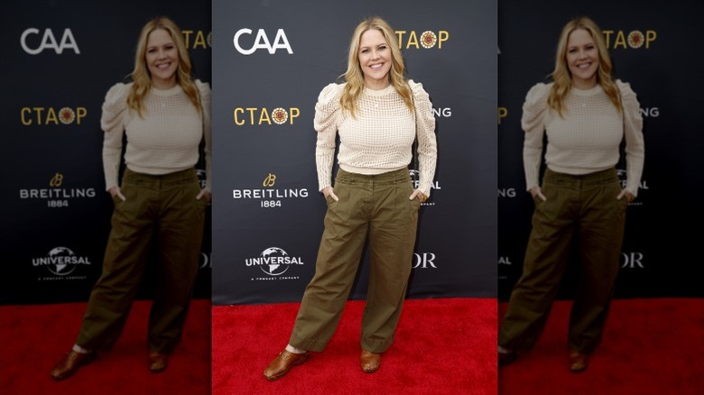 woman in brown clogs with green pants