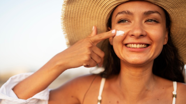Woman applying sunscreen.