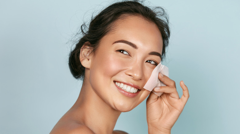smiling woman blotting face