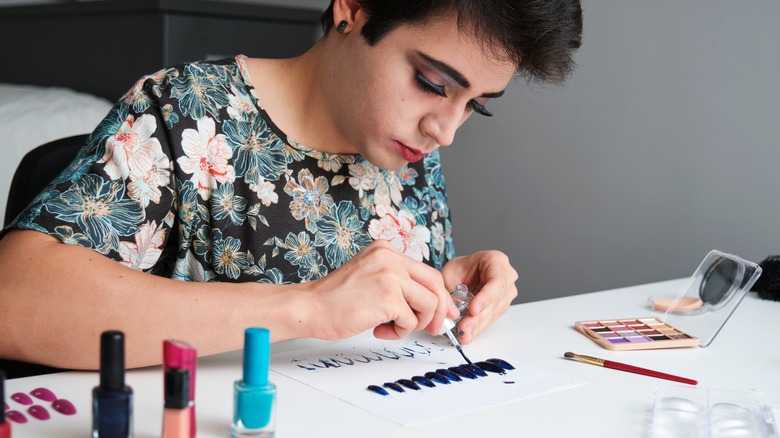 man painting his nails 