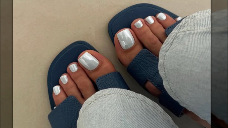 A pedicure with silver chrome nail polish.