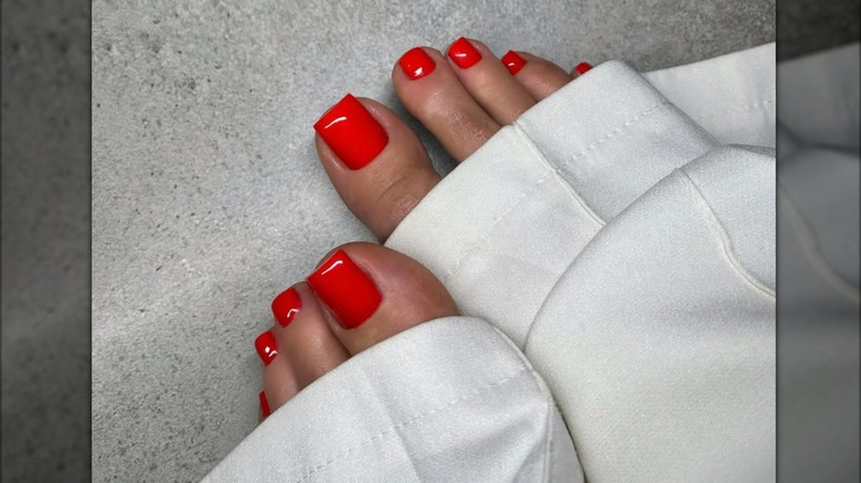 Pedicure with bright red nail polish.