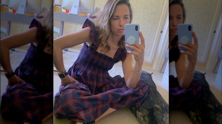 Woman taking selfie in plaid nap dress