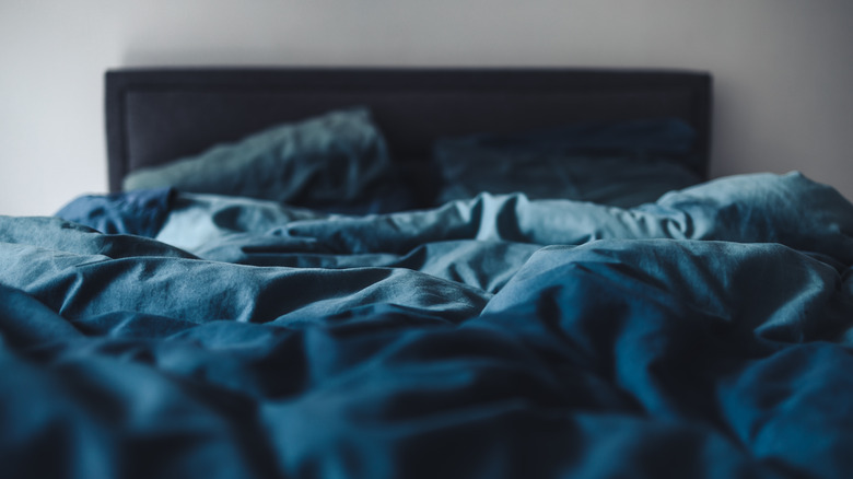 bed with navy blue sheets