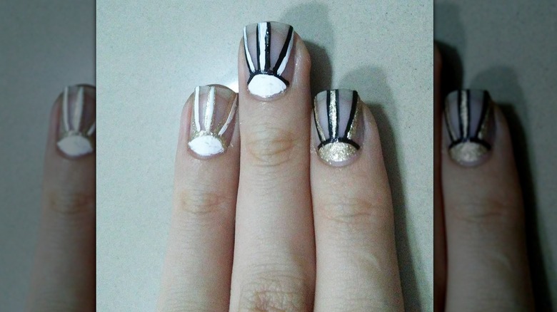 White, black, gold negative space manicure
