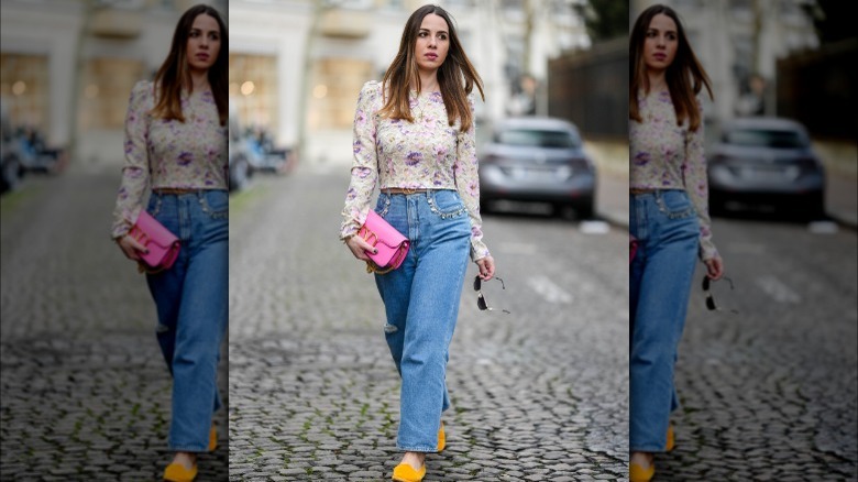 woman holding neon pink clutch