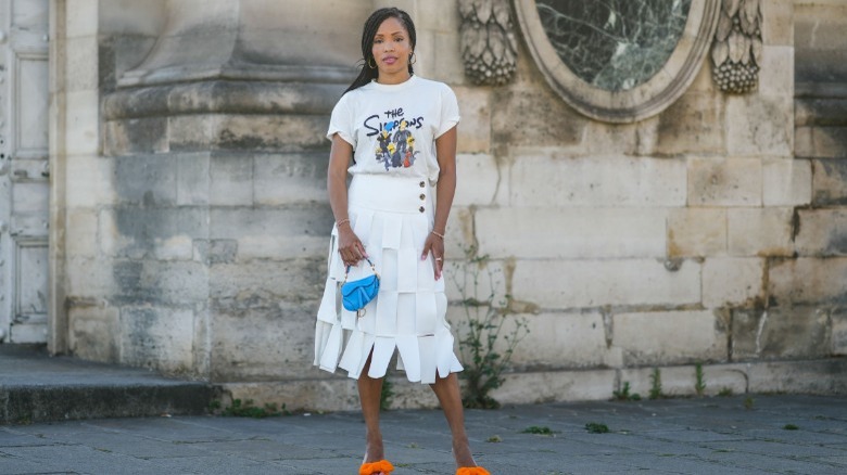 woman holding micro blue bag