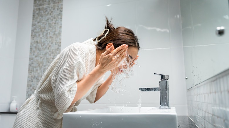 Woman washing her face