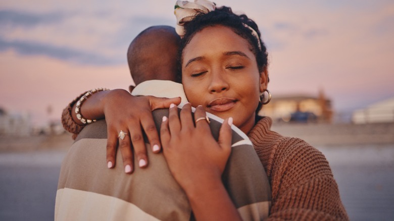 Short couple hugging on beach