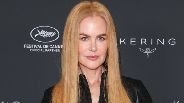 Nicole Kidman wearing a black outfit with long, straight strawberry-blond hair