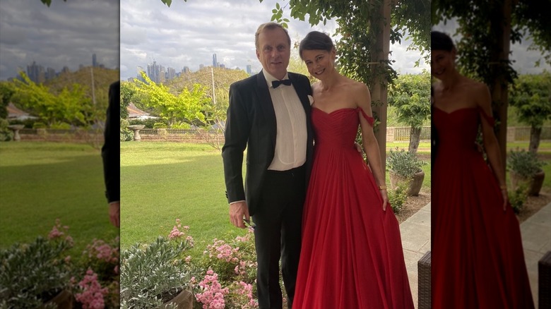 Antonia Kidman posing in a red dress with her husband Craig Marran