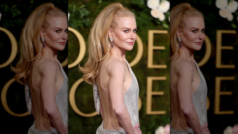 Nicole Kidman posing at the Golden Globes in 2025 with a long hair piece