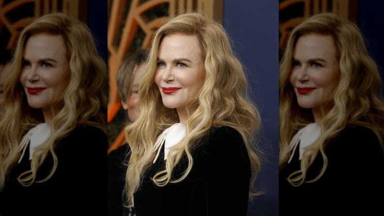 Nicole Kidman posing with voluminous blond waves on the red carpet at the SAG Awards
