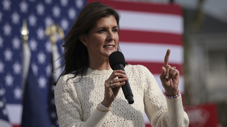 Nikki Haley speaking into a microphone in white