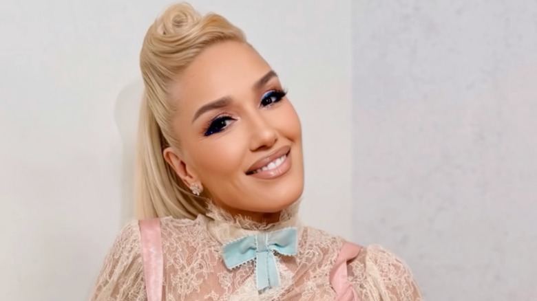 Gwen Stefani smiling in her pink lacy outfit at the 2025 American Music Awards