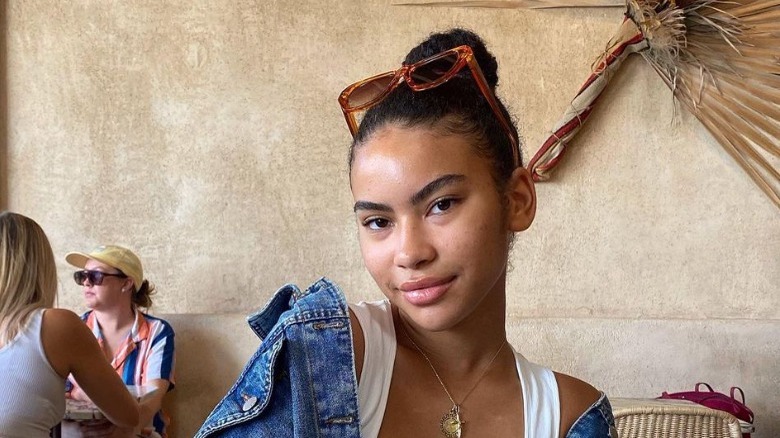 Woman wears high slicked-back bun