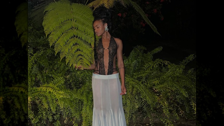 Woman wearing lace top with cutouts and flowy skirt