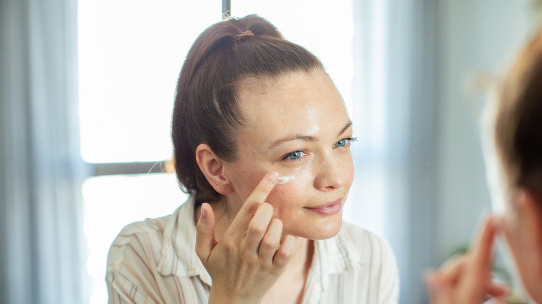 Woman applying eye cream