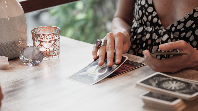 Person using tarot cards