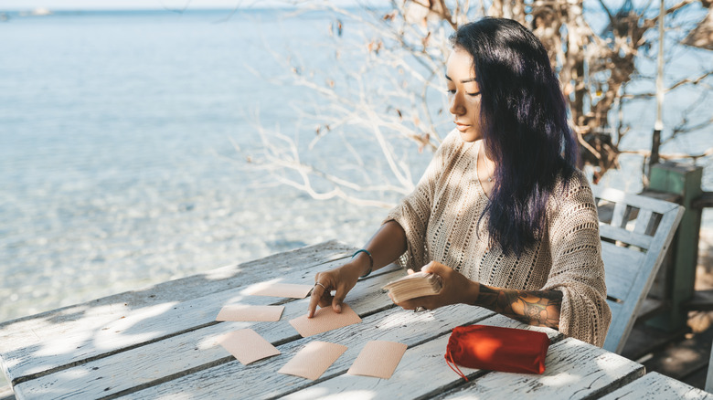 Woman using tarot cards outdoors