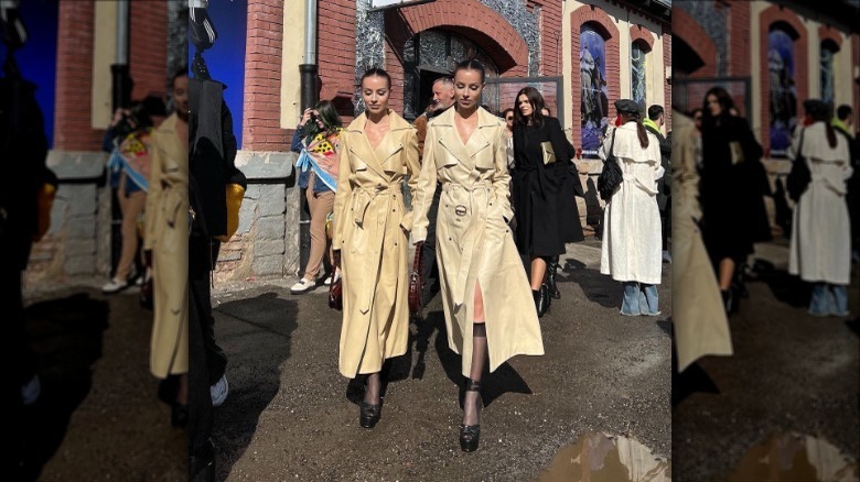 tan leather trenchcoat with black knee-high stockings
