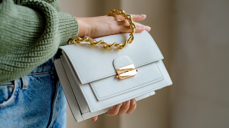 Holding white purse gold buckle