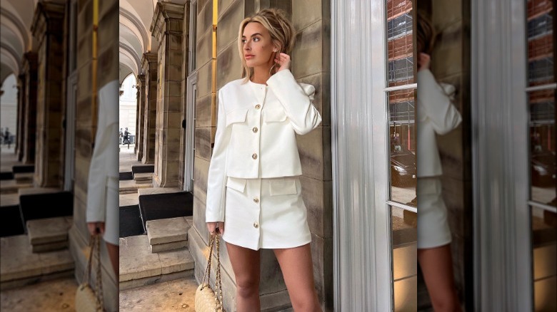 Woman poses wearing 1980s inspired skirt suit