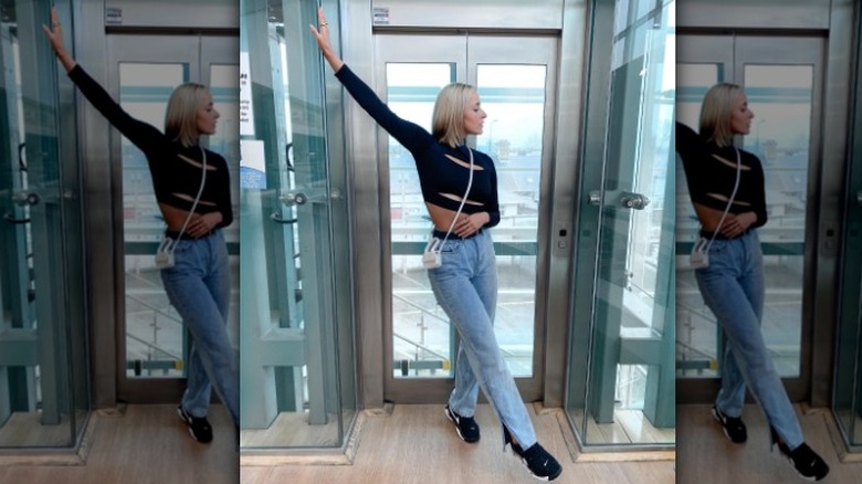 Split-hem jeans and black top and sneakers