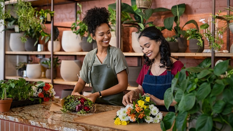 Two women arranging flowers